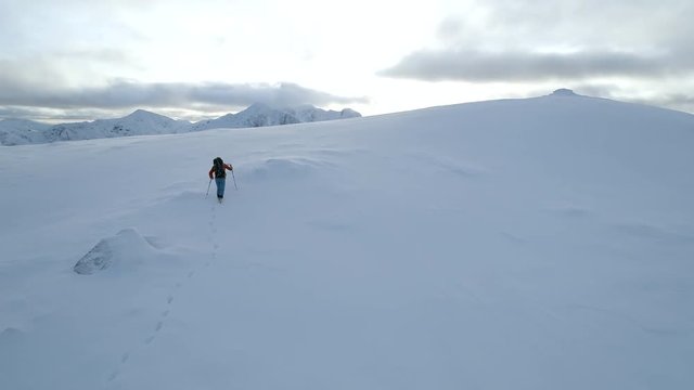 Mountaineer On The Final Ascent to the Summit of a Snowy Mountain