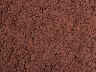 Texture background. Cocoa  chocolate brown powder Top view
