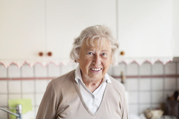 Smiling elderly woman in kitchen