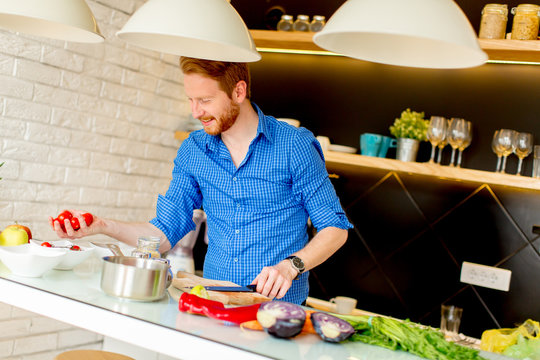 Redhair young man cooking food