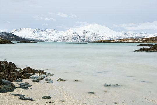 Scenery of lake and mountains covered in snow