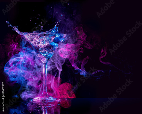 “cocktail splashing and multicolored smoke in a black background” Stock
