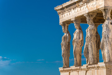 Close up of the Caryatids of the Erechtheion. A caryatid is a sculpted female figure serving as an architectural support taking the place of a column or a pillar supporting an entablature on her head. - obrazy, fototapety, plakaty