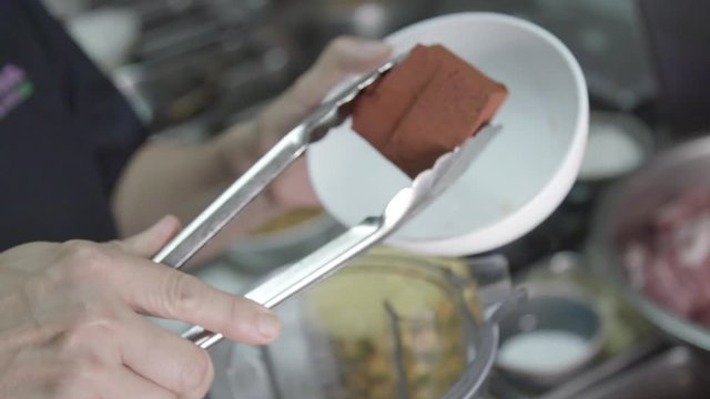 Slow motion close up, chef prepares mojo sauce