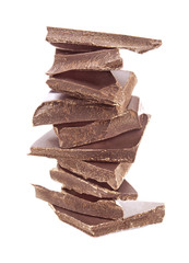 Broken chocolate pieces on white background.
