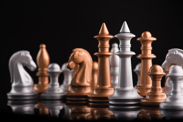 A series of gold and silver chess pieces