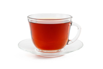 Glass cup of tea with saucer on white isolated background