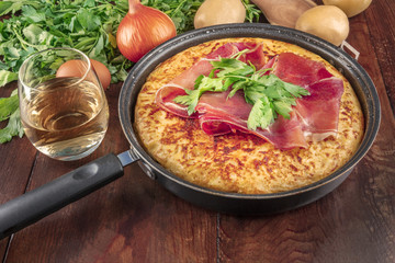 A closeup photo of a Spanish tortilla with ingredients