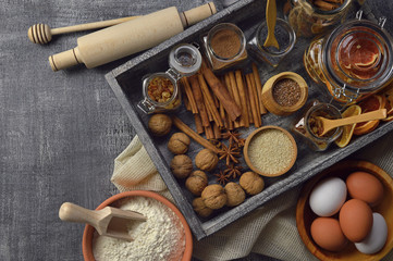 Fototapeta na wymiar A plurality of spices and cooking utensils. Natural products. Food background. Top view. Rural style.