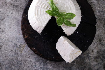 A fresh ricotta with basil leaf on wooden table italian food concept
