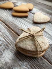 Lovely gingerbread heart shaped cookies with tie. Valentines day background. Homemade backing. Flat lay, top view.
