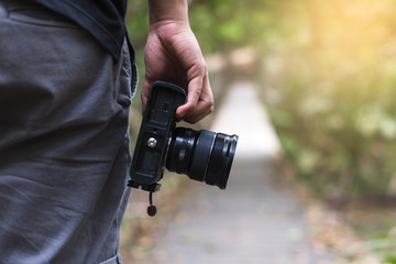 male photographer, hand hold camera, outdoor