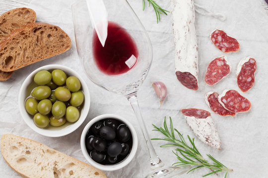 Salami, sausage, olives and wine