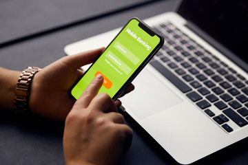 Female hands sign up for banking with a mobile phone in the office