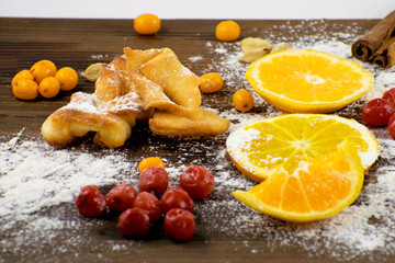 Cooking. Christmas baking: fir tree made from flour on a dark board, frozen berrys.