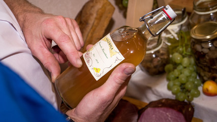 man deciding bottle of alcoholic tincture