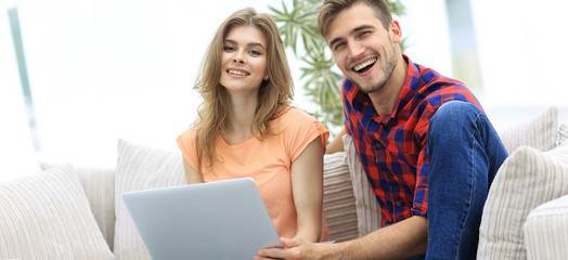 smiling couple resting at home,sitting on the couch.