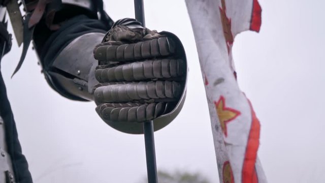 Hand knight's gauntlet that holds the flag