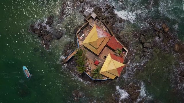Top view buddhist temple on island in ocean drone footage