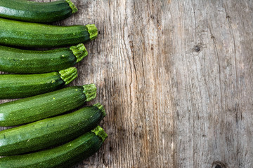 Fresh zucchini, green vegetables on local farmer market, freshly harvested courgette, summer squash