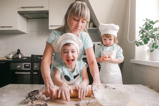 Happy family shape the dough for baking