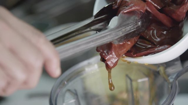 Chef prepares mojo sauce, close up