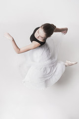 Obraz premium The top view of the teen ballerina on white background
