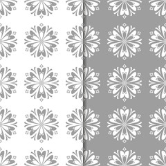 White and gray floral ornamental designs. Set of seamless patterns