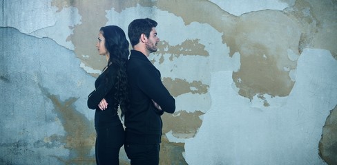 Obraz na płótnie Canvas Composite image of profile view of sad couple standing back to
