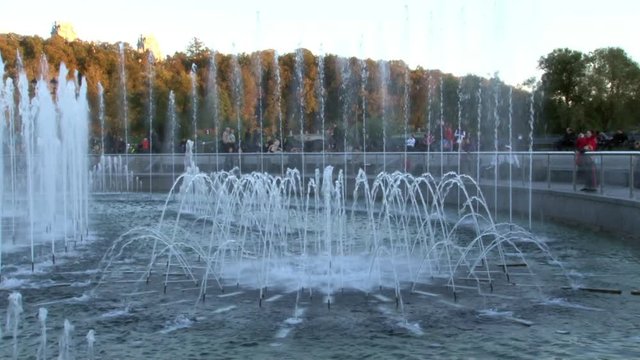 People in park near fountains in summer in Moscow. Beautiful views of capital of Russia.