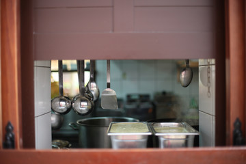 A window in the wall between the kitchen and the dining room