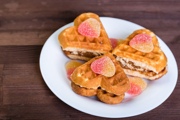 Cakes in the form of hearts are on a white plate.