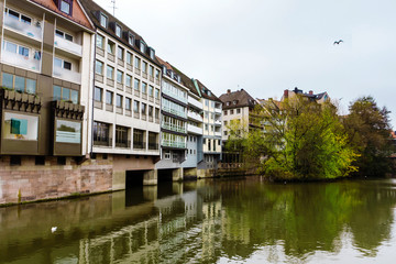 Calm river in historical Bavarian city with bridge and old houses. Nurnberg. Bavaria, Germany.