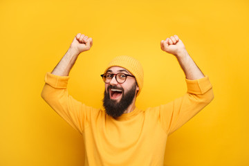 Man in yellow clothes feeling happy