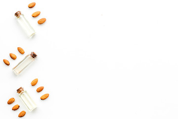 Oil for skin care. Almond oil in glass bottles on white background top view copy space