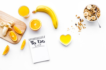 Morning habits of successful people. Healthy breakfast porridge with fruits and planning the day. White background top view copy space