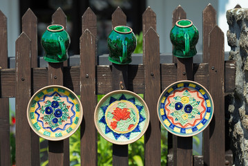 Hand-made crockery dryed on fence