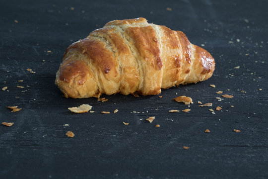 Flaky Croissant On Black Surface