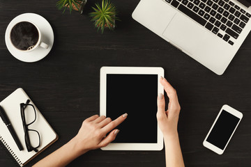 Woman's hands on digital tablet, top view