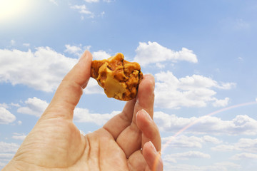 Amber in the hand with a bright reflection on the palm against the background of the sea.