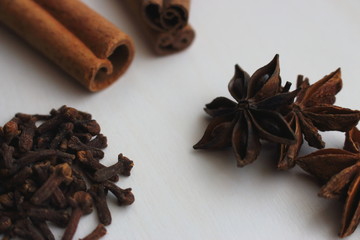Cinnamon sticks and anise stars closeup on white background. Cooking and baking background. Aromatic condiment and spices. Healthy food ingredients. Cooking decoration. Desserts ingredients.