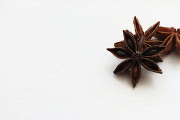 Anise stars closeup on white background with copy space. Aniseed isolated.  Aromatic condiment. Healthy cooking. Organic spices.