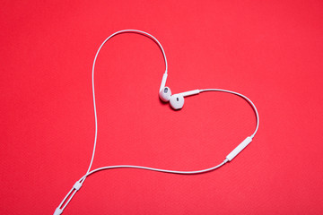 White headphones lined in the form of a heart