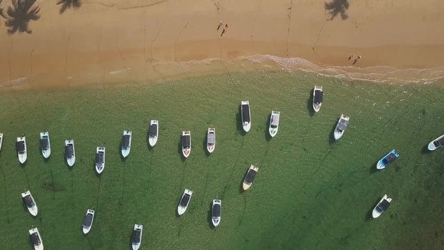 Top view beautiful beach line with boats in the ocean drone footage