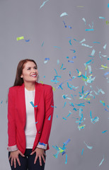 Beautiful happy woman at celebration party with confetti .Birthday or New Year eve celebrating concept.