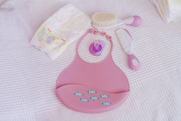 Pink Plastic Baby Bib ,Hairbrush and Diapers