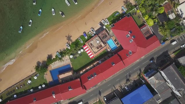 Top view aerial beach line with hotels and boats sunrise drone footage 