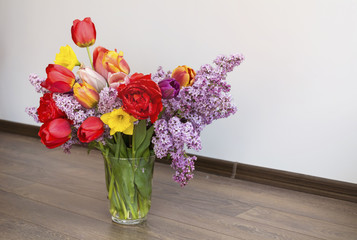 bouquet of red  tulips, lilac and narcissus