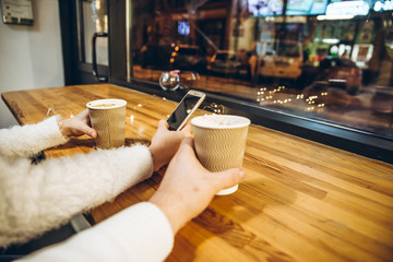 couple sit in cafe in front of big glass window