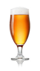 close-up view of cold glass of light beer with foam and drops